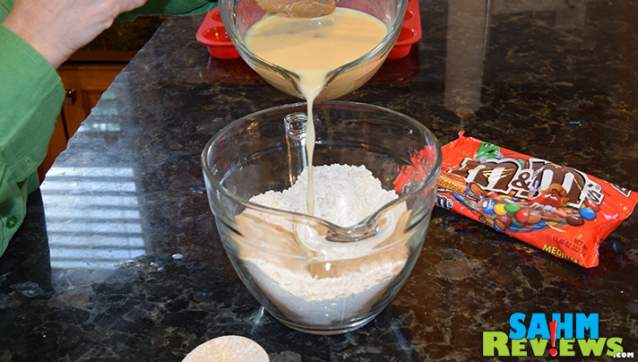 Combine the wet and dry ingredients for the PB M&M Muffin Recipe. - SahmReviews.com #HeroesEatMMs