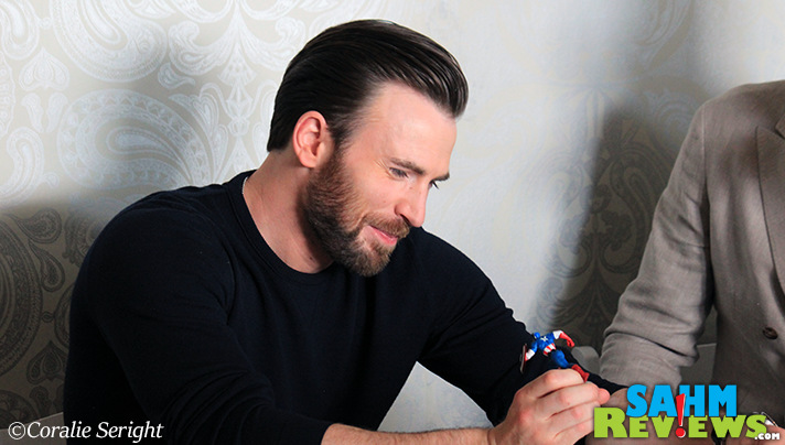 Chris Evans admires action figures prior to Captain America: Civil War premiere. Nothing like what he played with as a kid. - SahmReviews.com #CaptainAmericaEvent