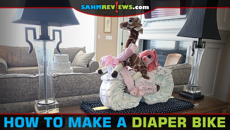 Make baby shower decorations functional by creating a diaper bike using diapers, receiving blankets, bottles and other items the mom-to-be will need. - SahmReviews.com