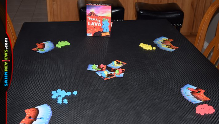 A flick of the cards can keep your meeples on safe ground or send others to their doom in The Table is Lava from R&R Games. - SahmReviews.com