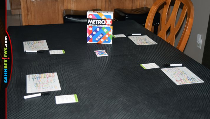 Feel the anxiety of mass transit during a trip to your game table in Metro X, a flip and write train-themed game from Gamewright. - SahmReviews.com