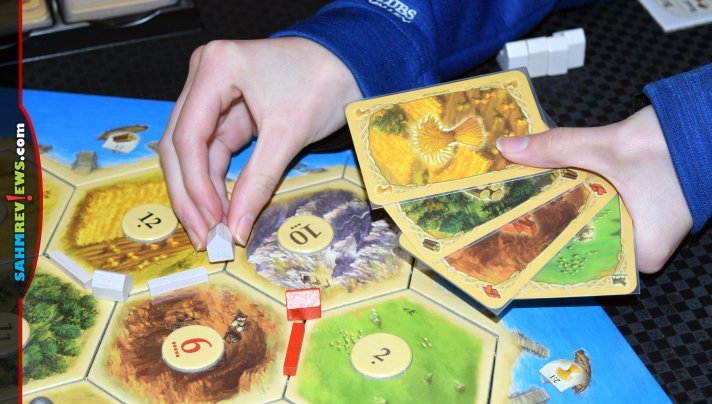 Catan 25th Anniversary Edition from Catan Studio includes custom dice, card sleeves, trays and pieces as well as an expansion for 5-6 players! - SahmReviews.com