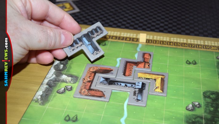 Every player's board changes differently depending on how they do each game in My City, a legacy game from Kosmos. - SahmReviews.com