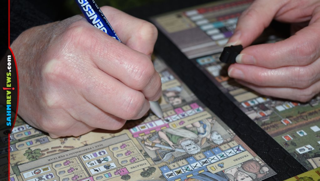 Hadrian's Wall player collecting game resource for marking a space on the tracking sheet. - SahmReviews.com