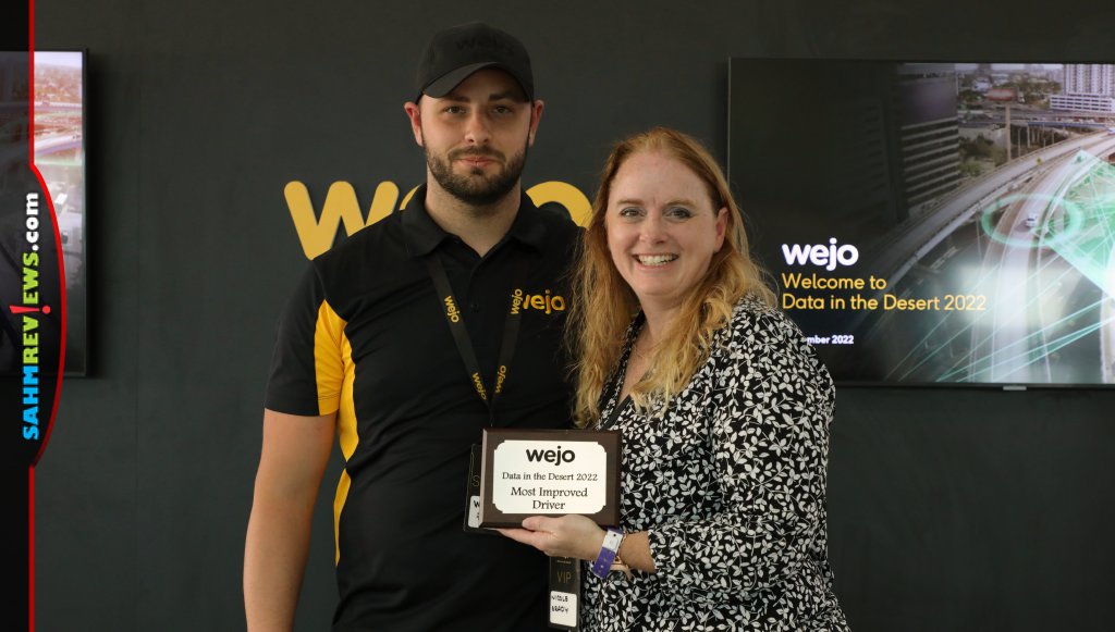 Professional racecar driver William Zollo and Nicole Brady holding Most Improved Driver plaque at Wejo Data in the Desert. - SahmReviews.com
