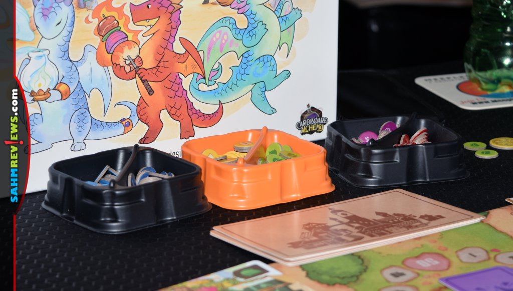 Flamecraft goods tokens stored in black and orange divided X-Trays from Lucky Duck Games. - SahmReviews.com