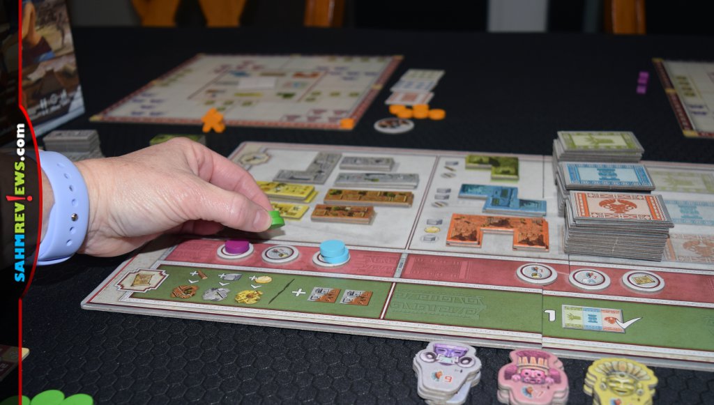 Placing disks to take action on main board in Founders of Teotihuacan. - SahmReviews.com