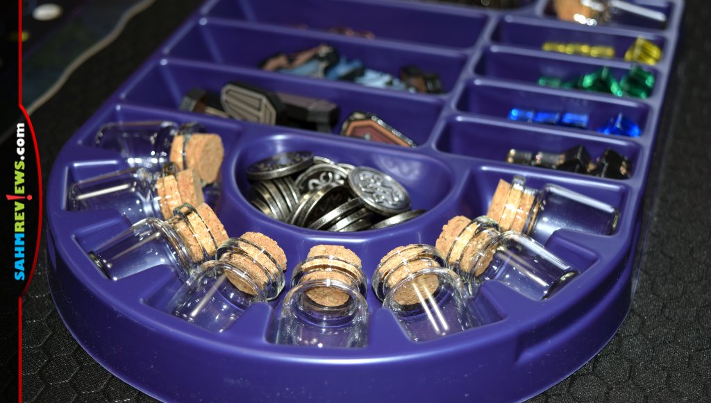My Father's Work game tray of components including metal coins and potion vials. - SahmReviews.com