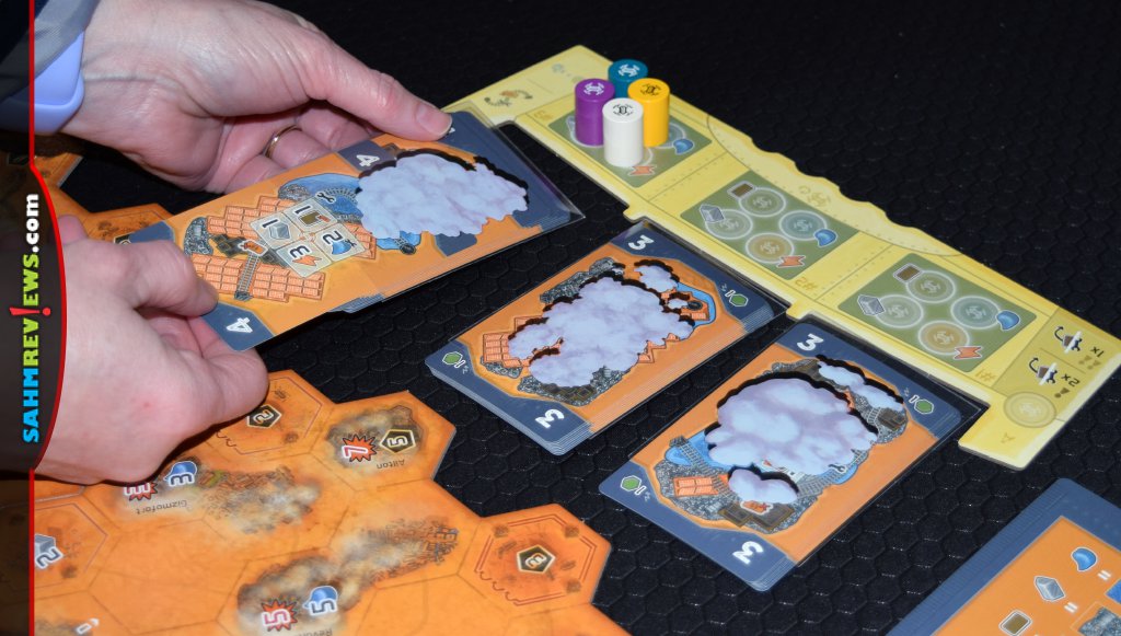 Gathering resources from the city board in CloudAge board game. - SahmReviews.com