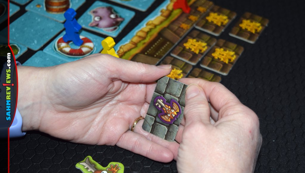 Checking to see if the key matches the temple tile in Kokonana family board game. - SahmReviews.com