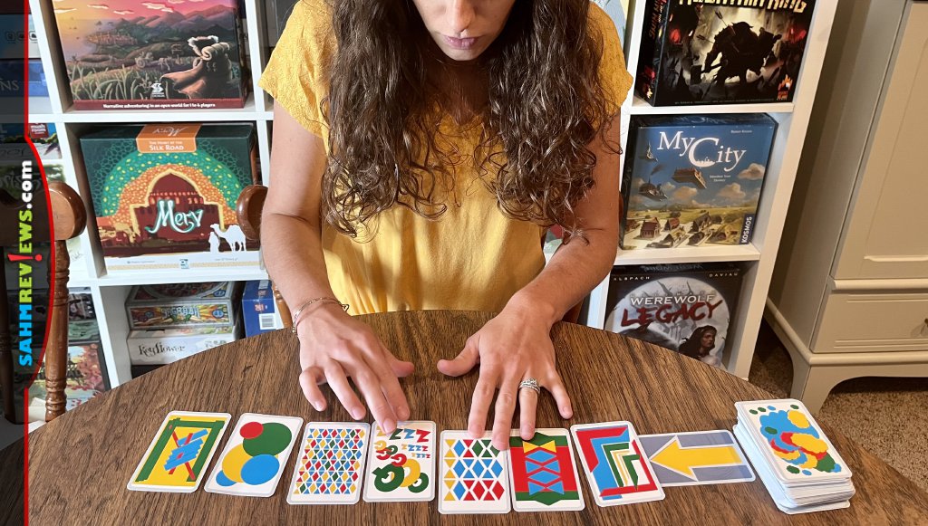 Female player adding Illusion pattern card to the row. - SahmReviews.com