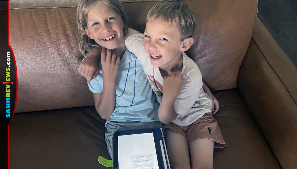 Siblings enjoying homeschool lessons with Smile Zemi educational tablet. - SahmReviews.com