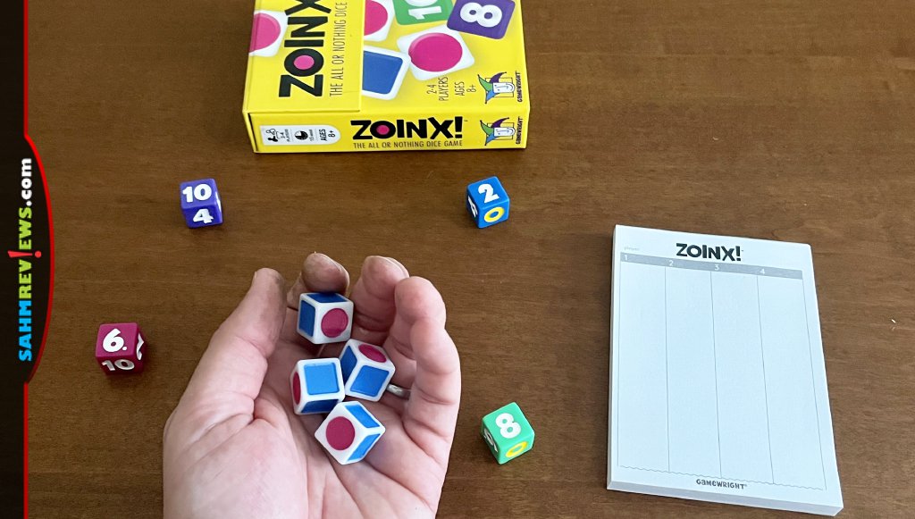 Zoinx! is a quick paced dice game where setup involves distributing dice and grabbing the scoring pad. - SahmReviews.com